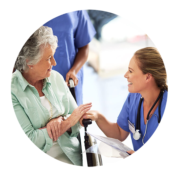 nurse helping elderly in wheelchair